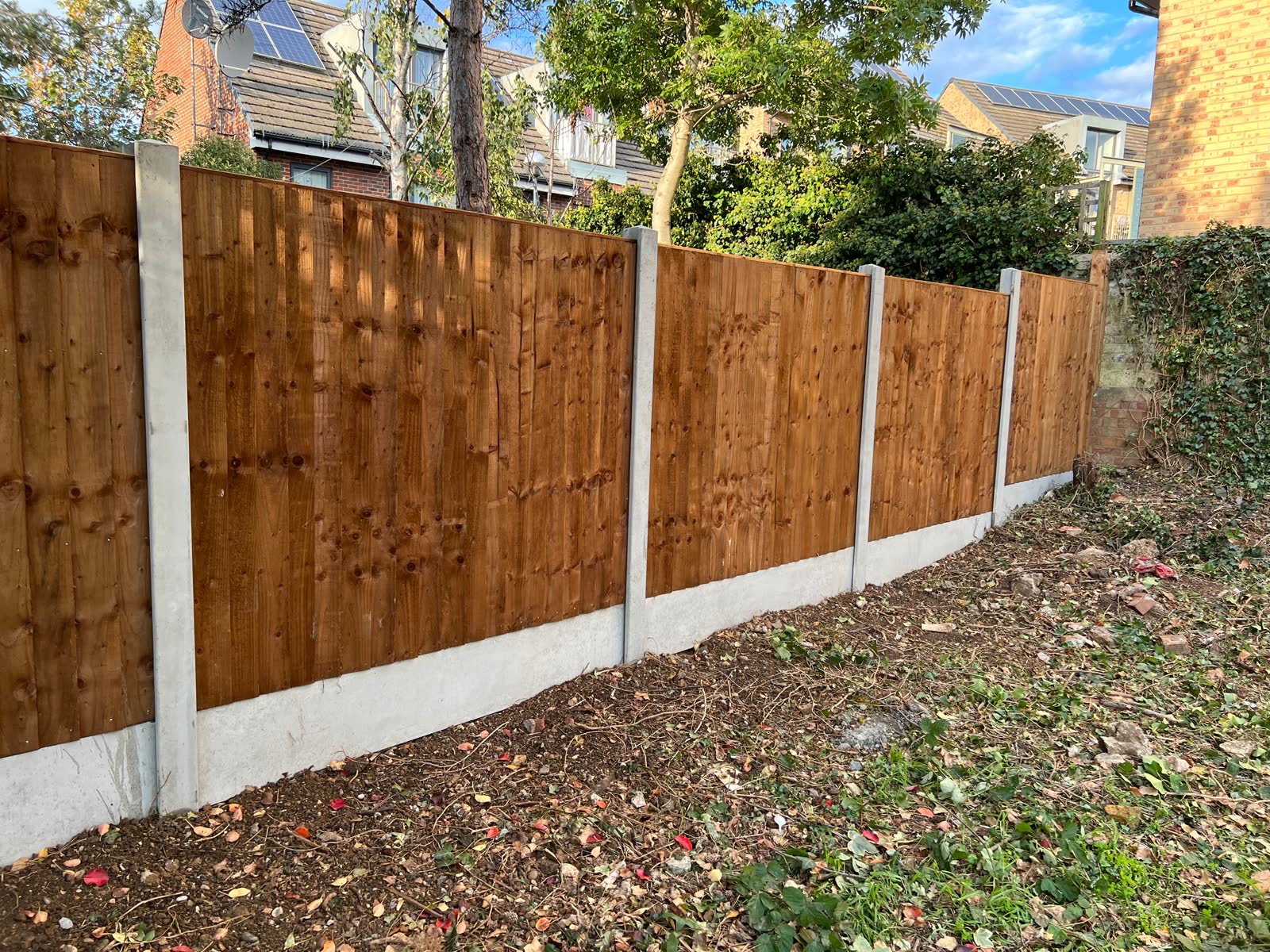 Long timber fence run beside a driveway